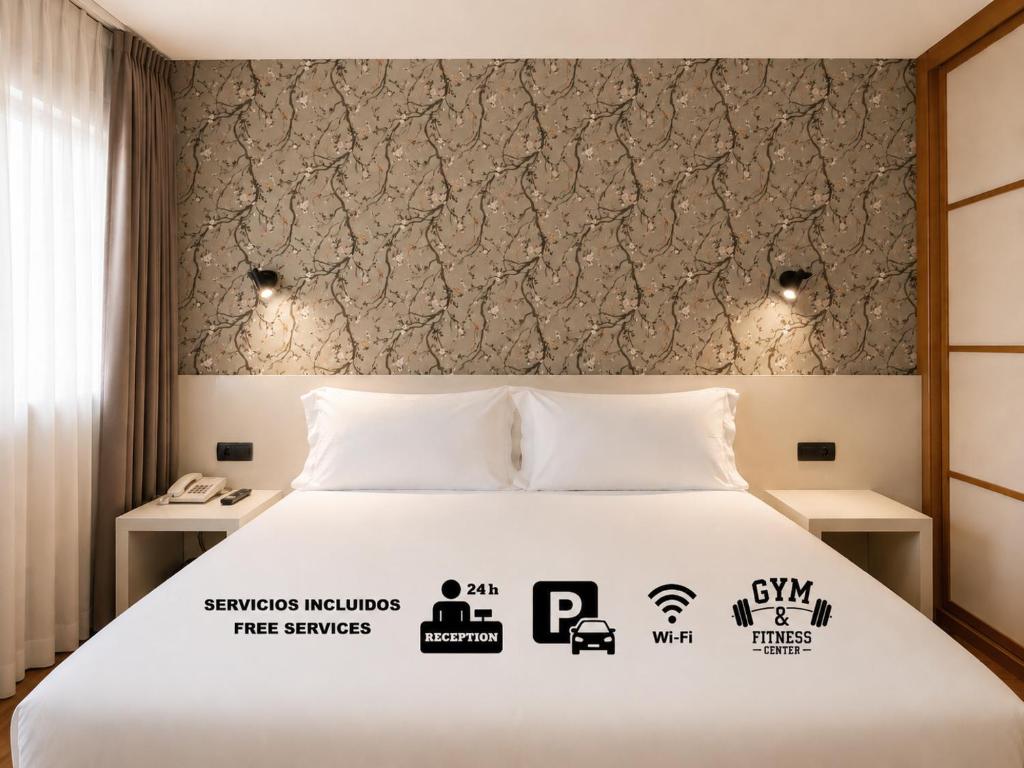a bedroom with a white bed with a wall at Hotel Apartamentos San Fermín Pamplona in Pamplona