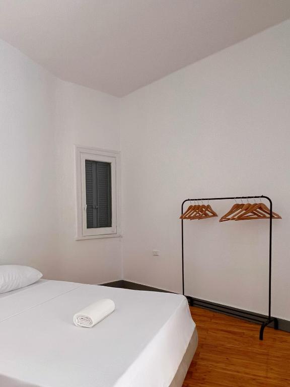 a white room with a bed and a window at Nile & Museum Hideaway Haraka in Cairo