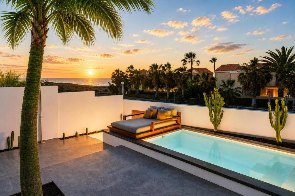 a villa with a swimming pool and palm trees at Casa Abora - Ocean Views, Private Pool & Sunsets in La Pared