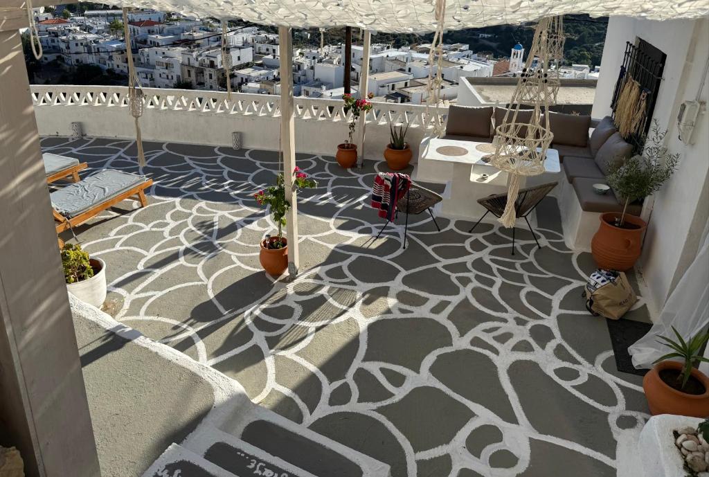 a balcony with a white and gray floor with plants at Vasiliki Skyros Castle View in Skiros