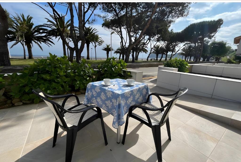 a table with a blue and white table cloth on it at Comillas 30 Primera Línea de Playa in Comillas