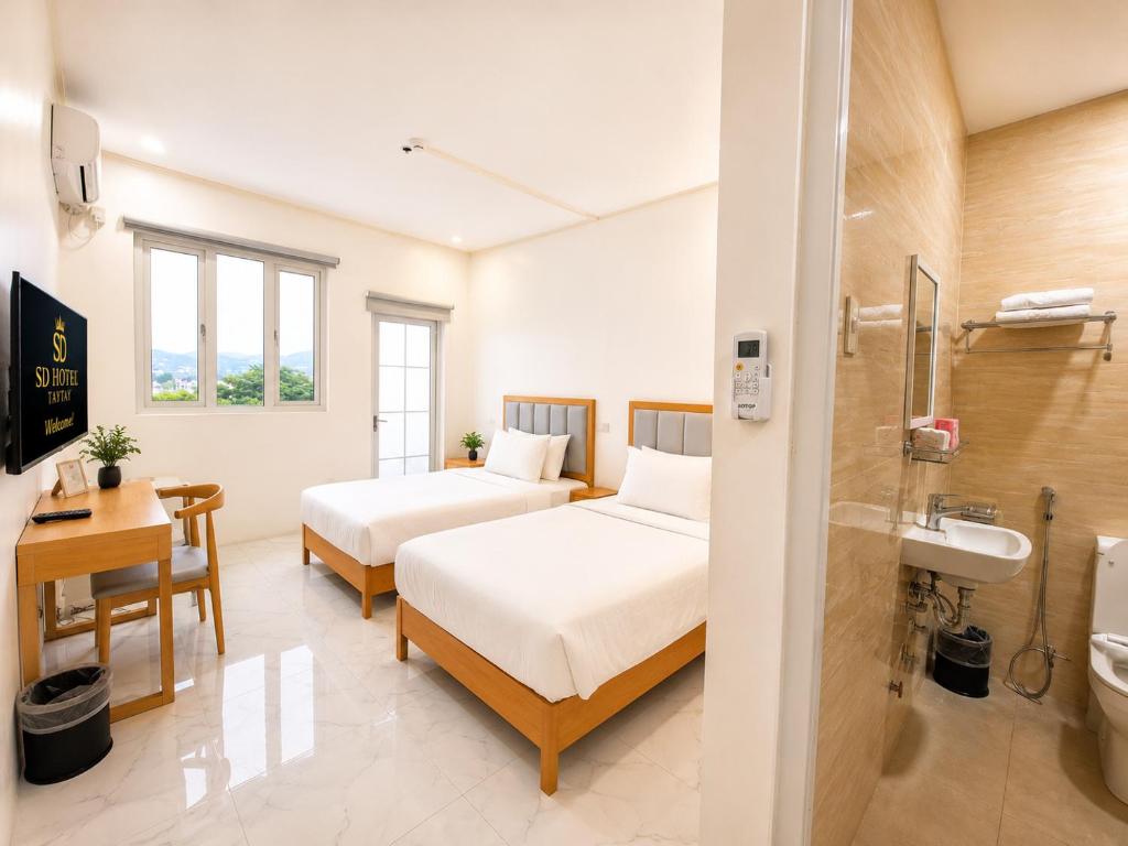 a hotel room with two beds and a bathroom at SD HOTEL Taytay in Taytay