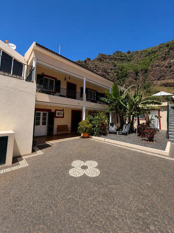 a building with a bike painted on the ground at Maresia's House, Madalena do Mar in Madalena do Mar