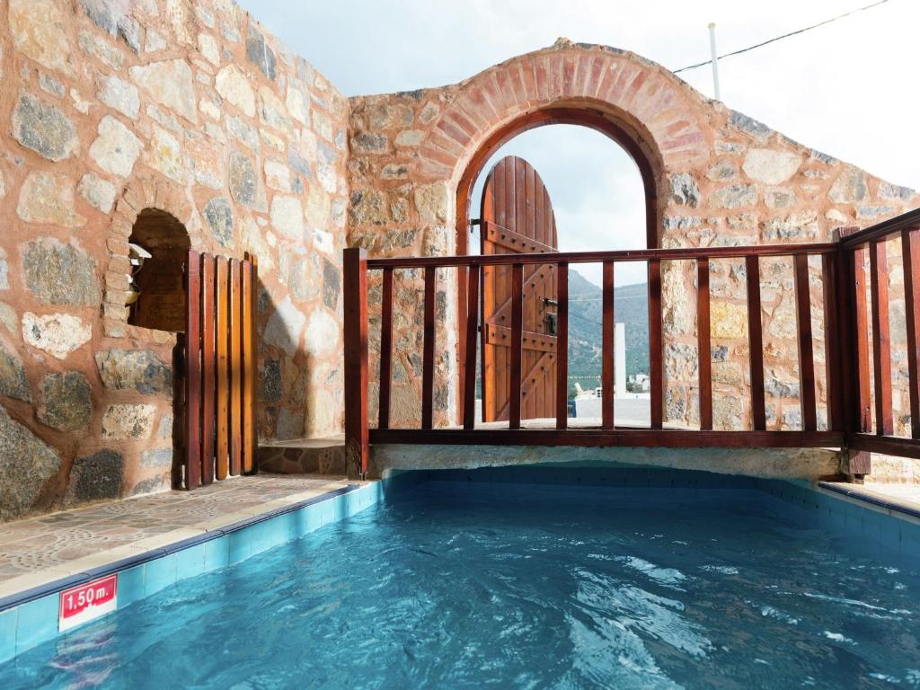 エロウンダにあるTraditional Apartment in Elounda with Swimming Pool near Seaのバルコニー付きの屋内スイミングプール、屋内スイミングプールを提供しています。