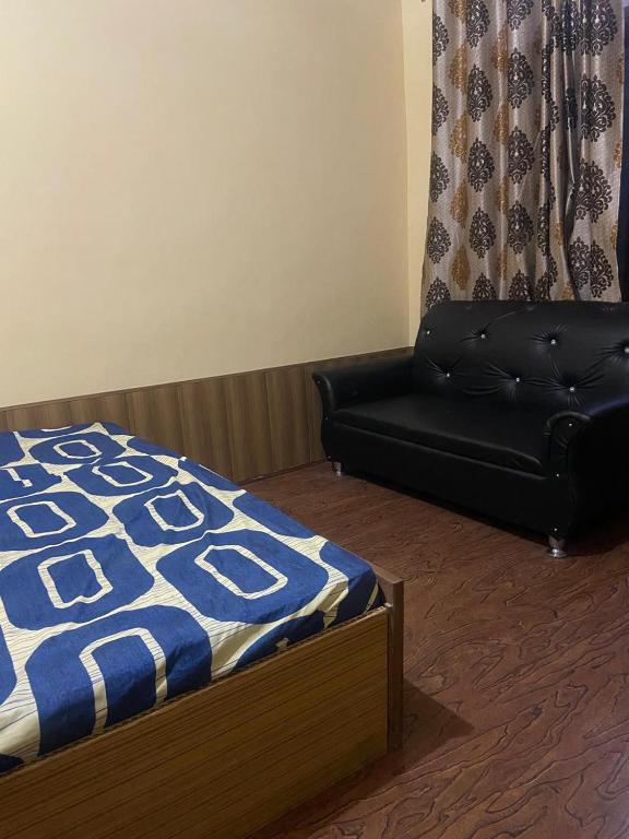 a bedroom with a couch and a bed and a couch at Ahmed Lodge in Harganyiwan