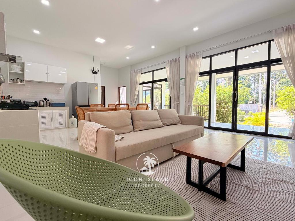 a living room with a couch and a table at Villa La Forest Koh Phangan in Ko Phangan