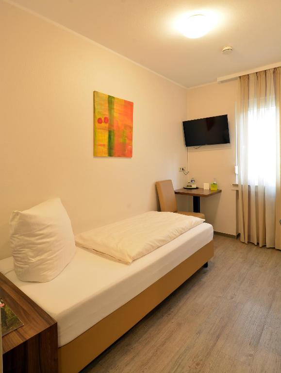 Postel nebo postele na pokoji v ubytování L' Angolo Ristorante & Hotel GmbH