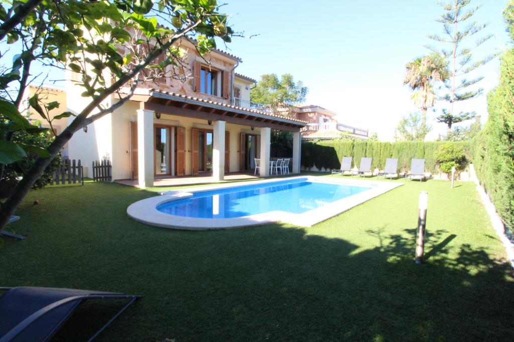 a house with a swimming pool in the yard at Villa Puerto Adriano in El Toro