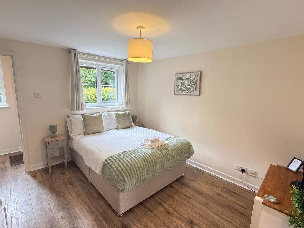 a small bedroom with a bed and a window at Modern studio flat in Wellington, Telford in Wellington