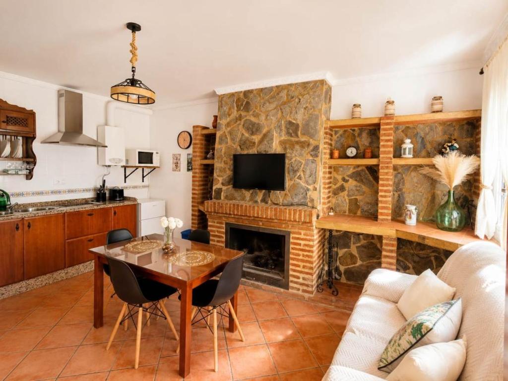 a living room with a table and a fireplace at Los Meri in Grazalema