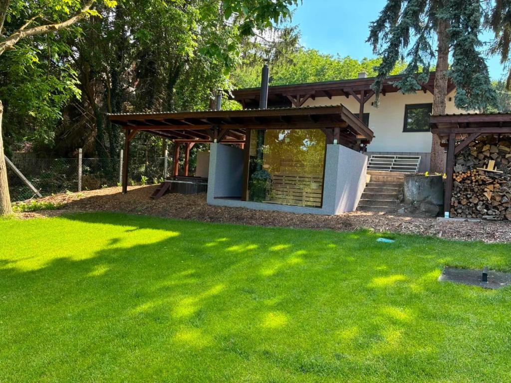 a house with a green lawn in front of it at Rác Relax in Rácalmás