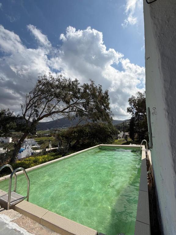 a green swimming pool in a building at 3 Bd Stonehouse with Swimming Pool in Paraspóri