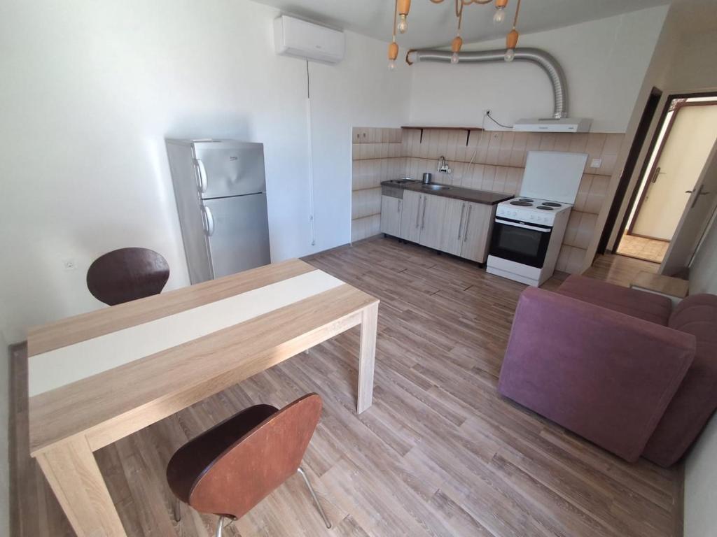 a kitchen and living room with a table and chairs at IgaloGomila in Igalo