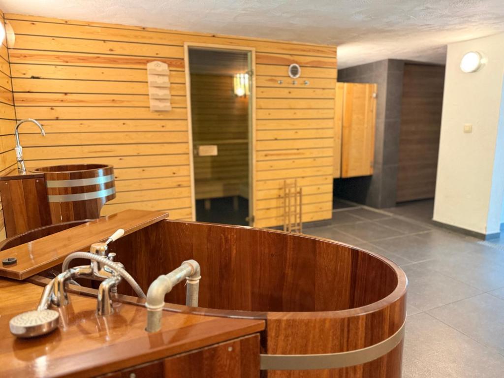 a wooden tub in a bathroom with a sink at Baron in Beffe