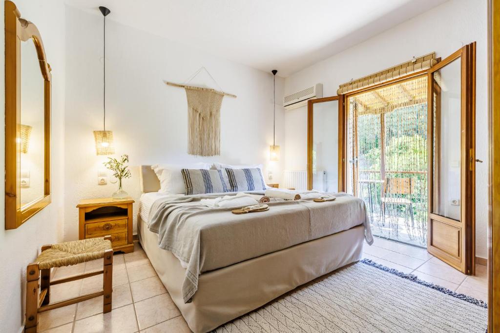 a bedroom with a large bed and a window at Casa Gaia in Panormos Skopelos