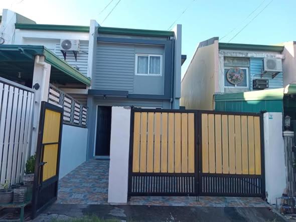 a house with a gate in front of it at 3G's & C Transient House Calapan in Camilmil