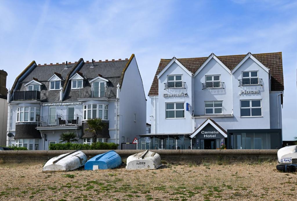 a large white house with boats in front of it at Camelia Hotel in Southend-on-Sea