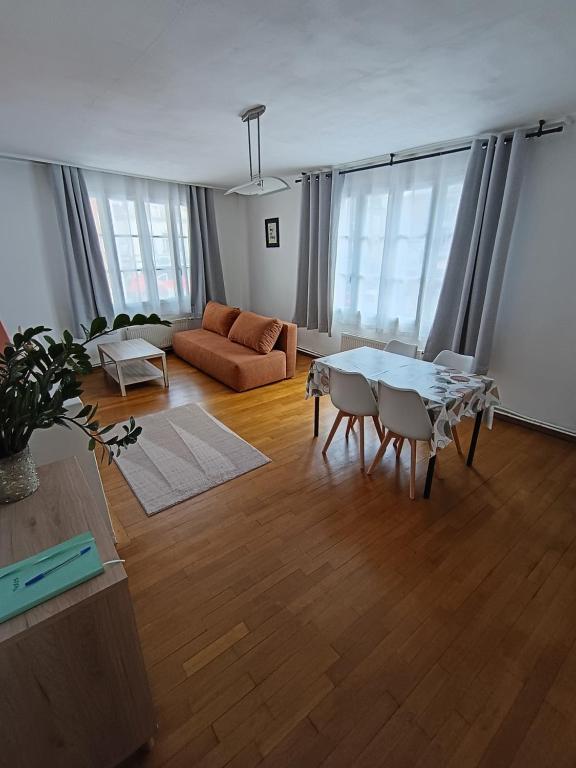 a living room with a couch and a table at Au cœur de Givet in Givet