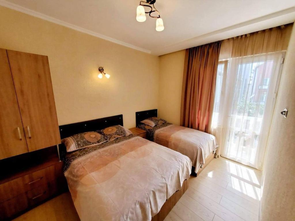 a hotel room with two beds and a window at cozy wave house ureki in Ureki