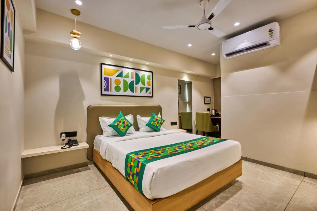 a bedroom with a large bed in a room at Treebo Rio Crown Palace in Ahmedabad