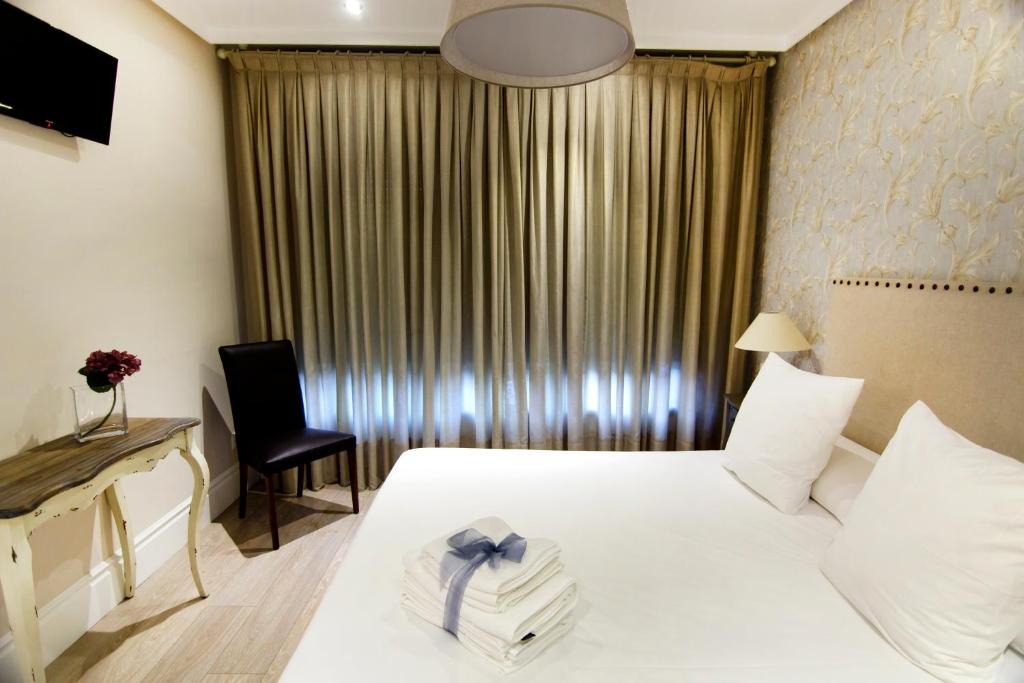Łóżko lub łóżka w pokoju w obiekcie Natura Petit Hotel