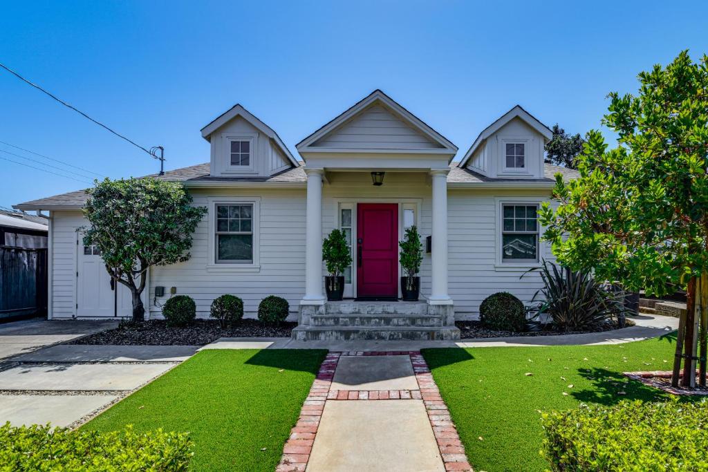 a white house with a red door at Walkable Mill Valley Gem: Private Patio + Yard in Mill Valley