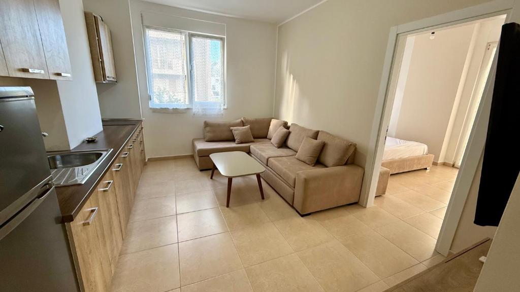 a living room with a couch and a table at EG Beach Apartments 105A in Lezhë