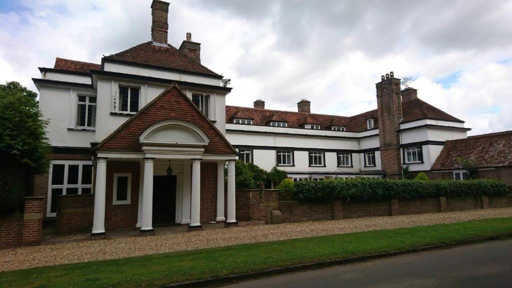 a large white building with a gazebo at Chartridge Lodge Hotel in Chesham