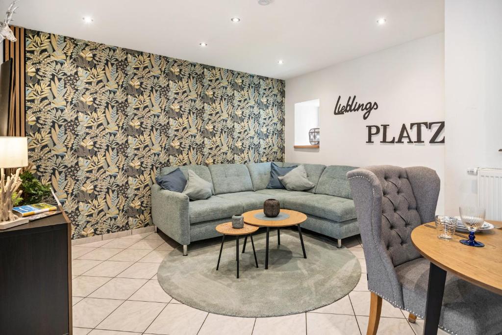 a living room with a couch and a table at Kleines Stadthaus mit Sauna in Hillesheim