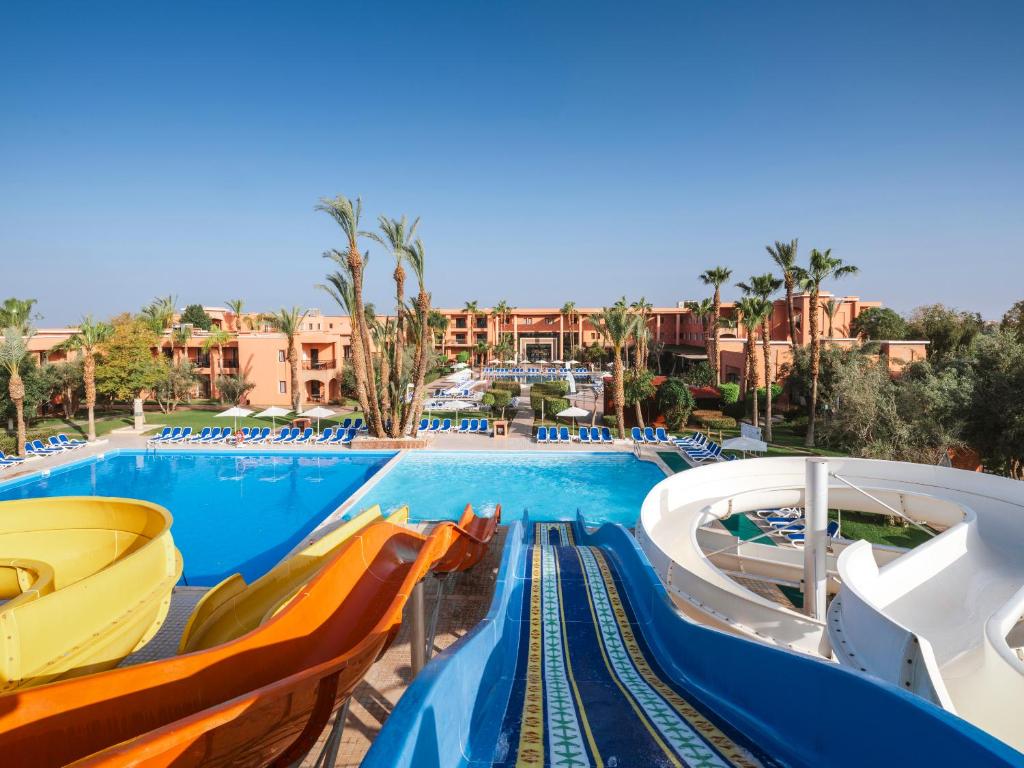 a large swimming pool with slides at a resort at Aqualis Club Resort Marrakech in Marrakesh