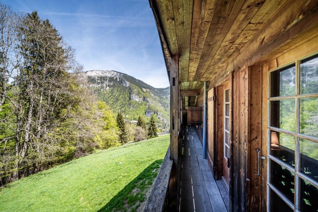 a log cabin with a view of a mountain at Chalet Familial Chaleureux in Abondance