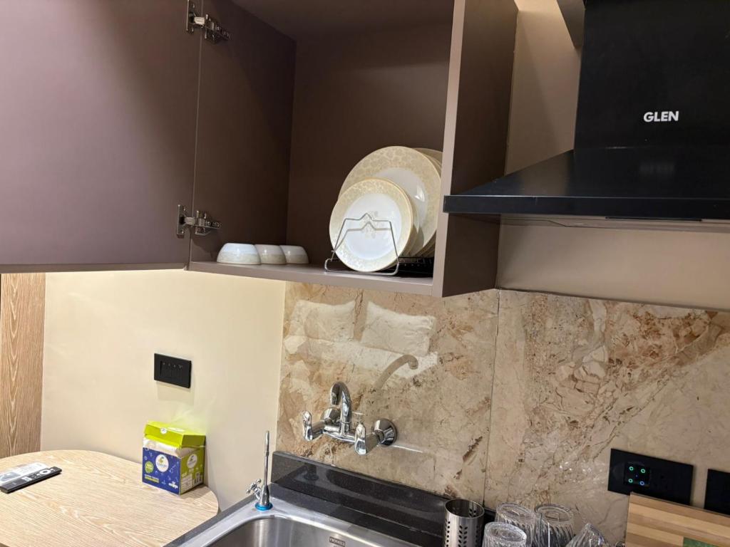 a kitchen with a sink and a counter top at Stay Karo Yaar in Ghaziabad