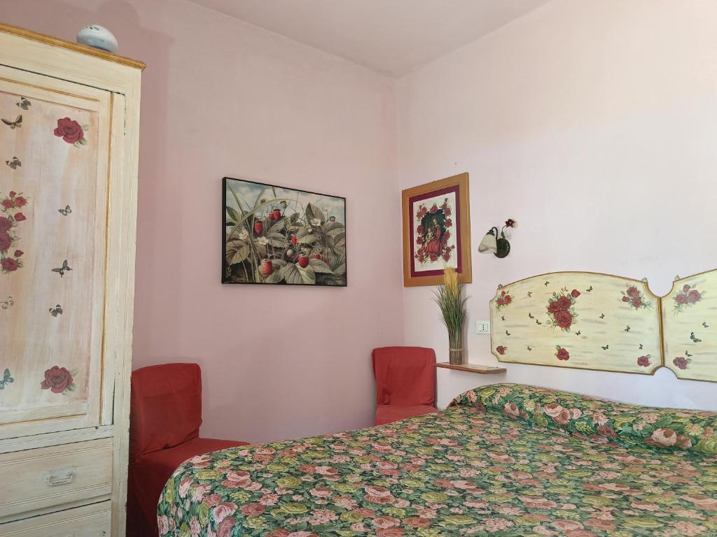 a bedroom with a bed and two red chairs at Appartamento Zero Pensieri in San Benedetto del Tronto