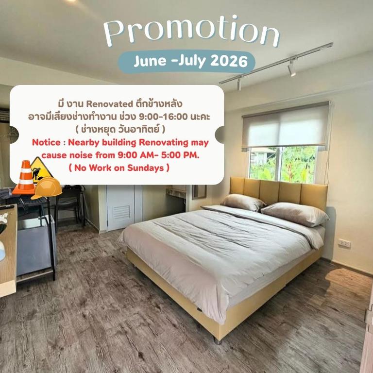 a bedroom with a bed and a desk in it at โรงแรมดีรูม D Room in Samut Prakan
