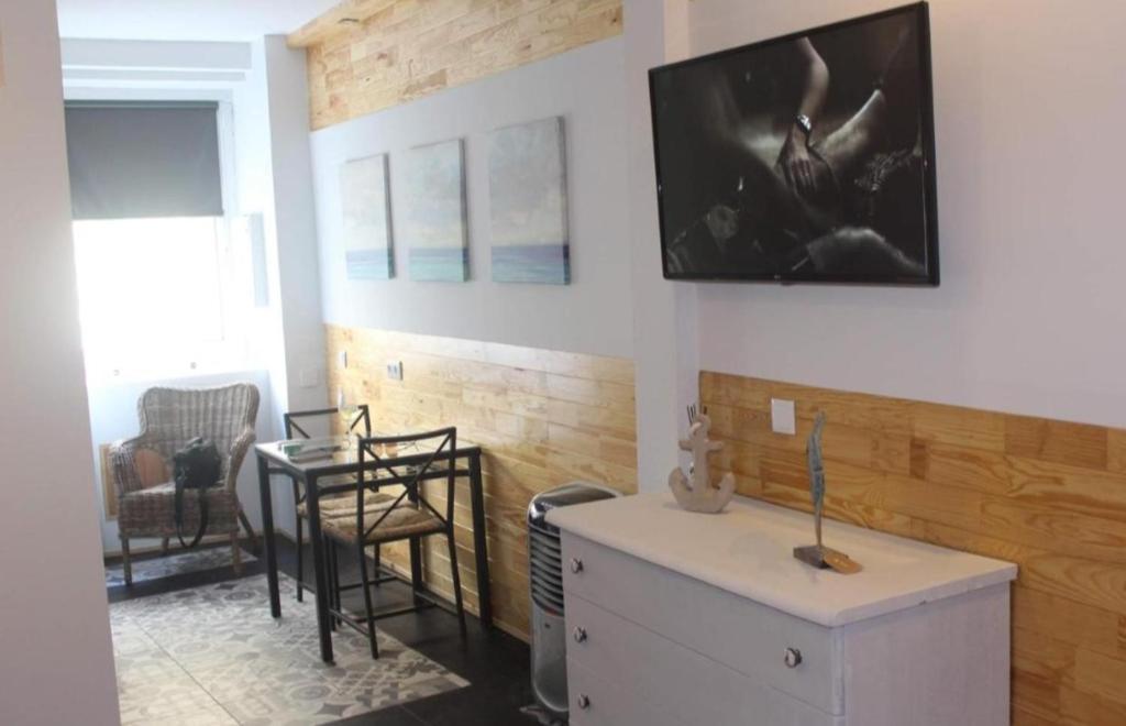 a kitchen with a counter and a table in a room at Villa Régio Studio in Vila do Conde