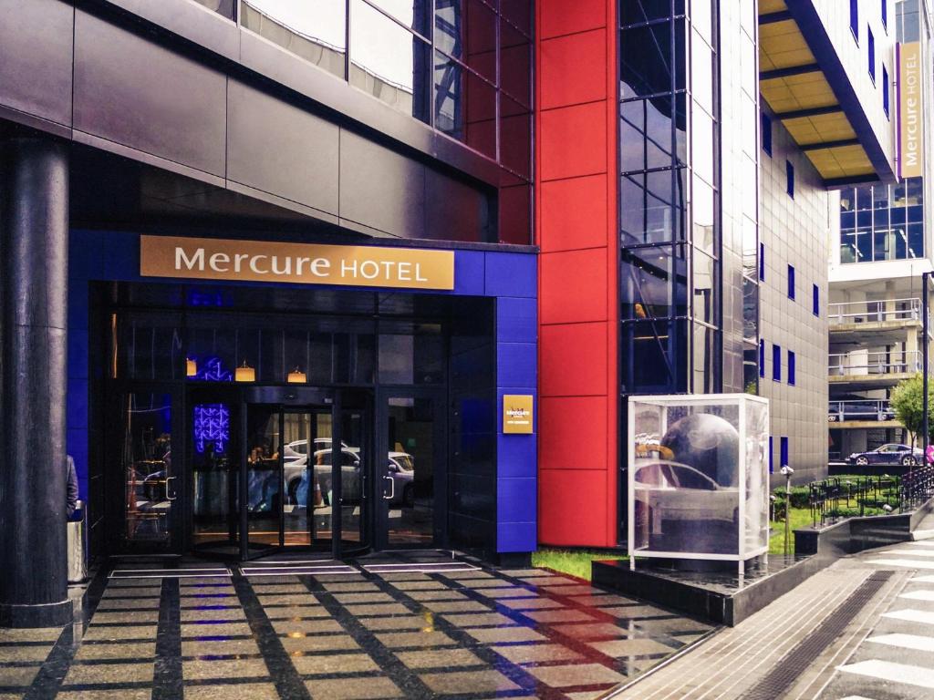 a facade of a metroure hotel on a city street at Mercure Kyiv Congress in Kyiv