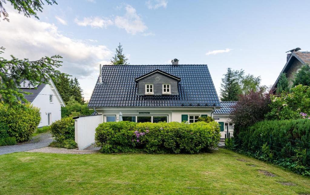 a white house with a black roof at Schneekäppchen 1 in Winterberg