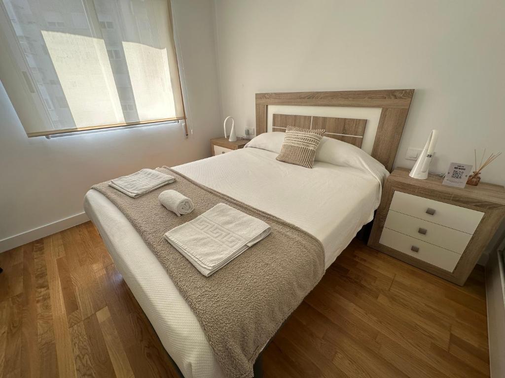 a bedroom with a large bed and a window at Candle Home Sáenz Díez in Ourense