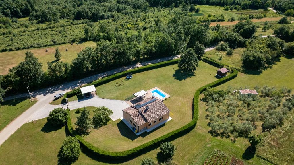 an aerial view of a house on a grassy field at Villa Elida with Heated Pool - Central Istria in Pazin