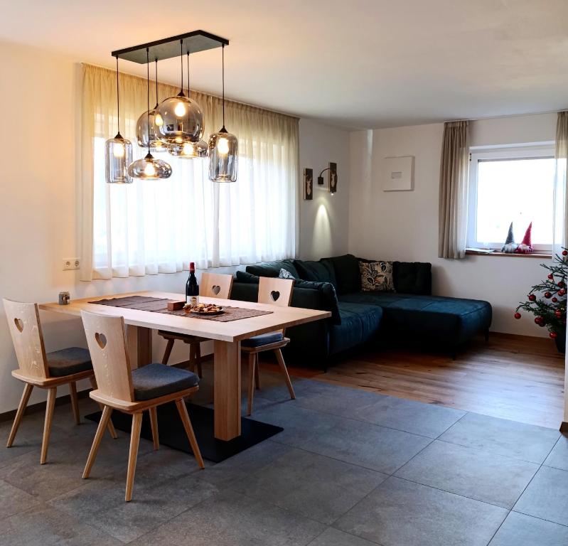 a living room with a table and a couch at Binterhof in Castelrotto