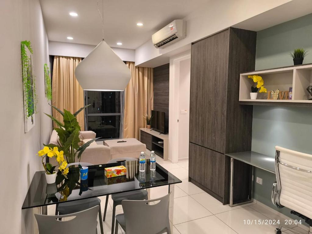 a kitchen and living room with a dining table and chairs at Robertson Luxury Apartment in Kuala Lumpur