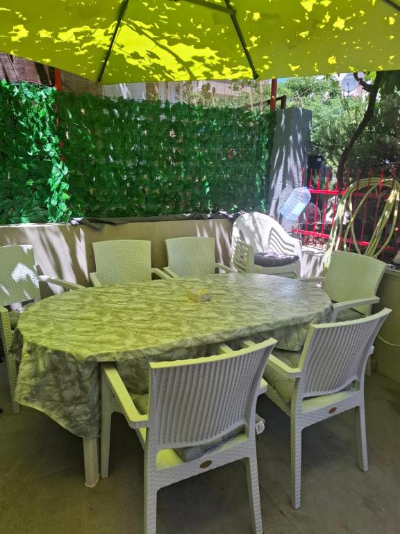 a table and chairs sitting under a tent at Radovići,Luštice in Radovici