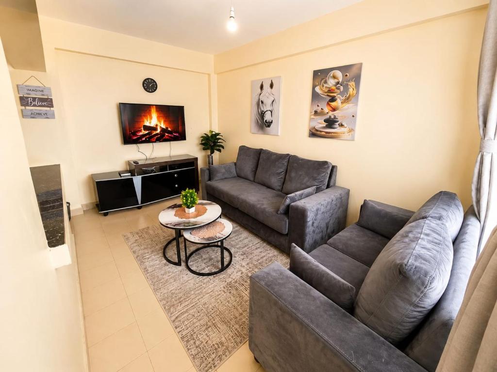 a living room with a couch and a table at Fahari House in Embu