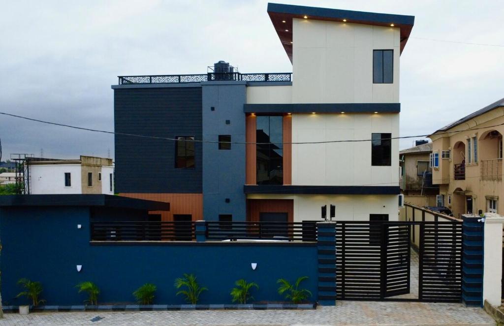a house with a blue and white at The Crest Triplex in Ikeja