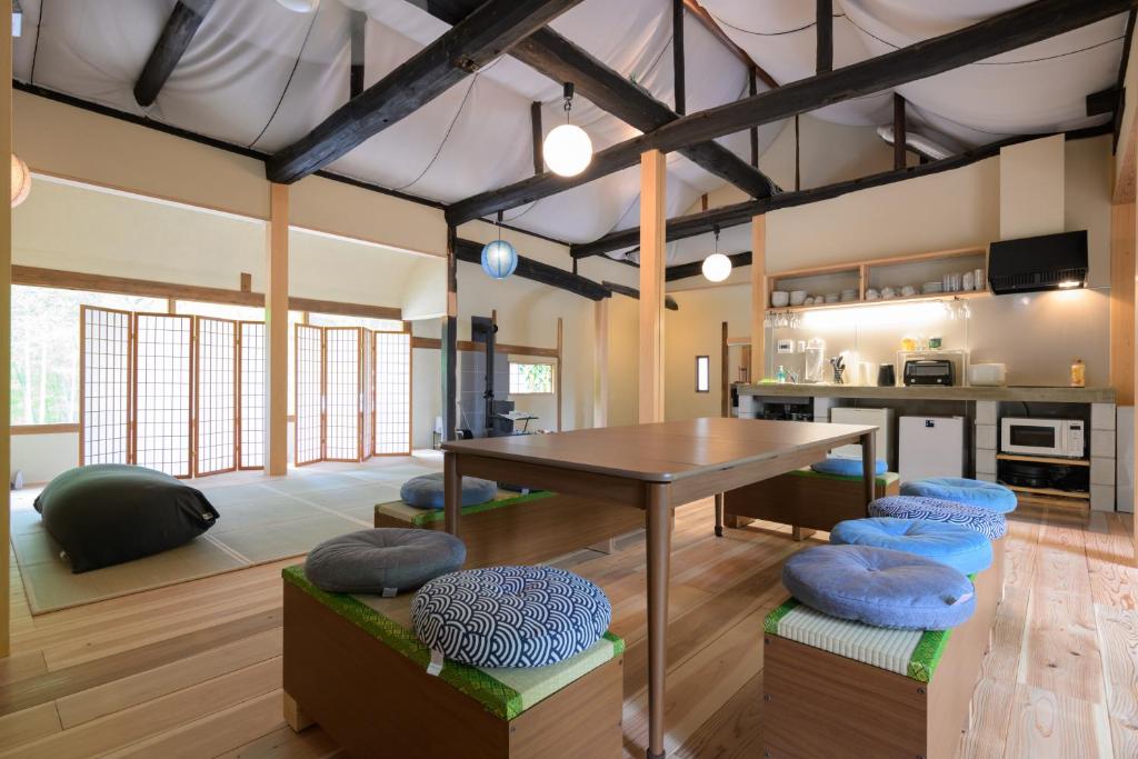 a living room with a table and blue chairs at 高野神谷宿 一結 in Koyasan