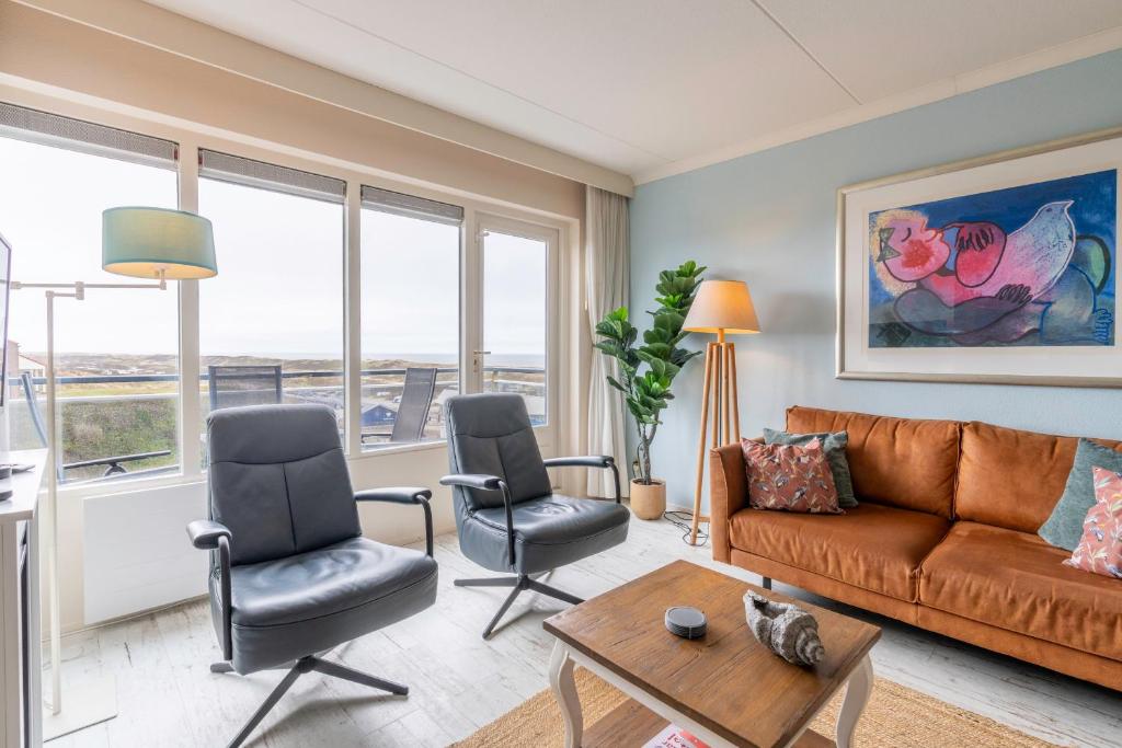 a living room with a couch and two chairs at Appartementencomplex Juliana 148 in De Koog