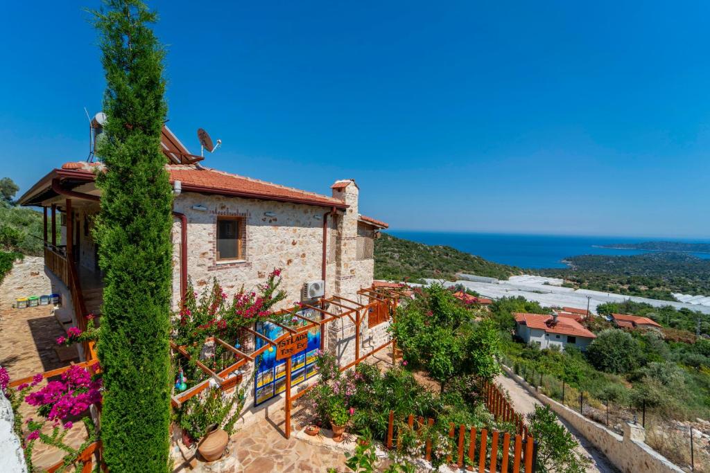 a building with ivy on the side of it at Istlada Taş Ev Apart - Kekova Island View in Demre