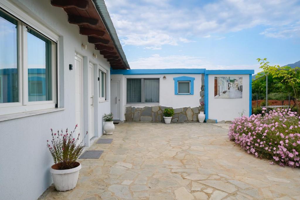 a patio of a house with potted plants at STUDIOS TASOS BI in Chrysi Ammoudia