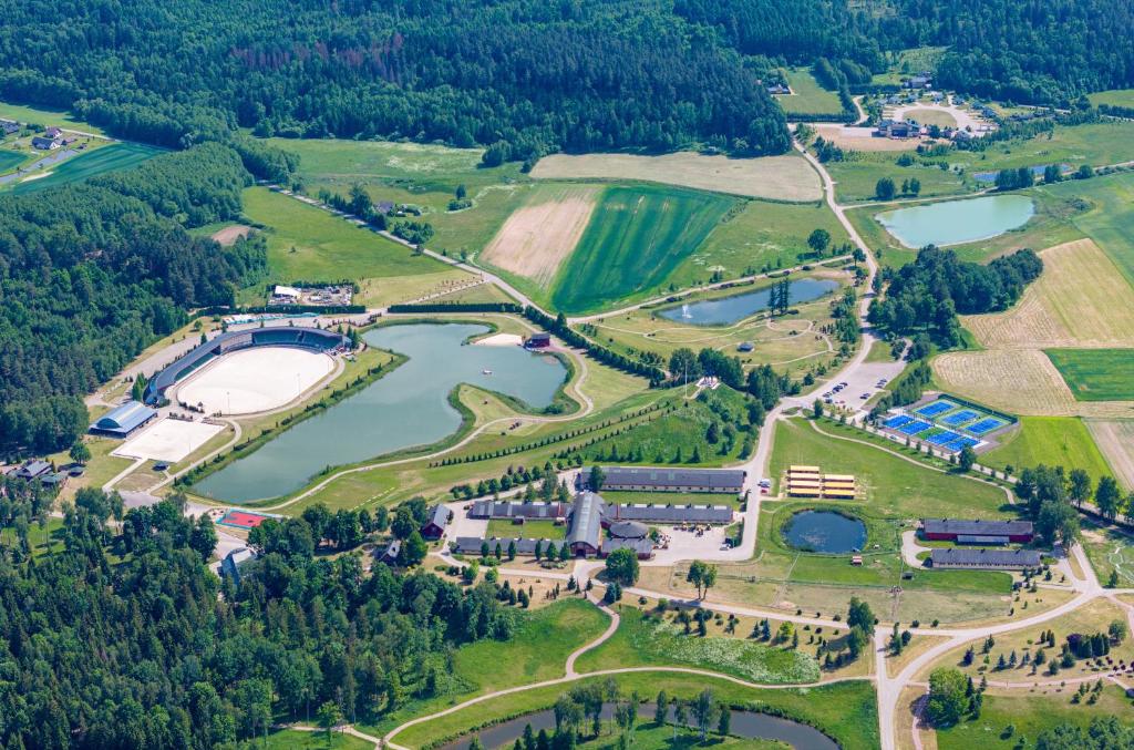 an aerial view of a park with a lake at Harmony Park Countryside Villas & SPA in Prienai