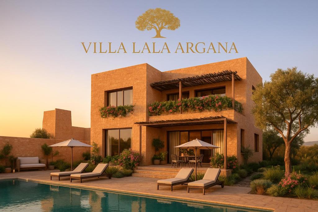 a building with chairs and a pool in front of it at Villa Lala Argana in Essaouira
